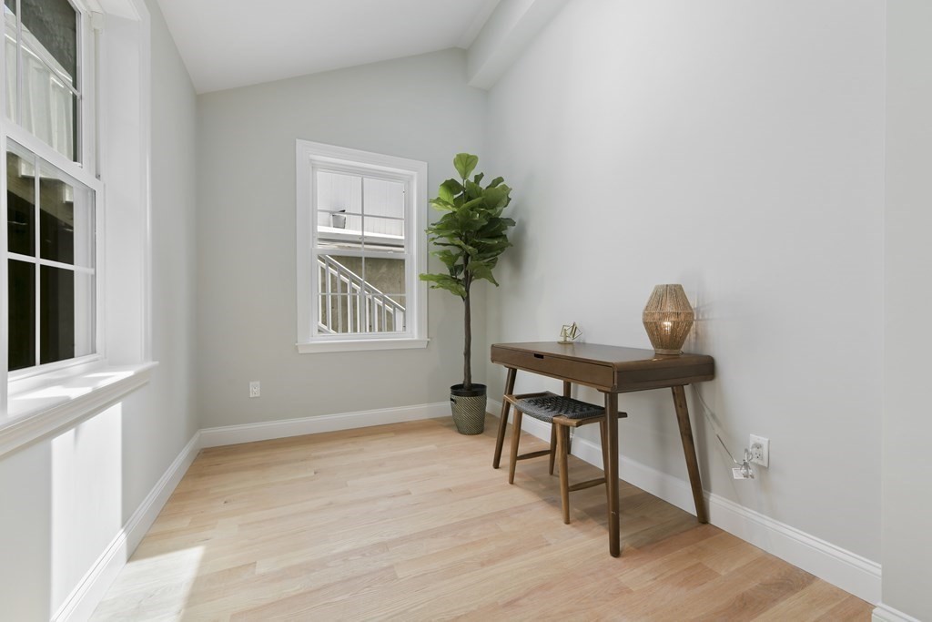 25 Locust Street, Unit 1 Winthrop, MA 02152 - Photo 17 of 38 a view of a workspace room with wooden floor and windows