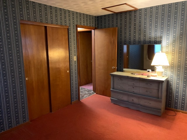 209 Southview Drive Rochelle, IL 61068 - Photo 7 of 16 a bedroom with a bed and a mirror