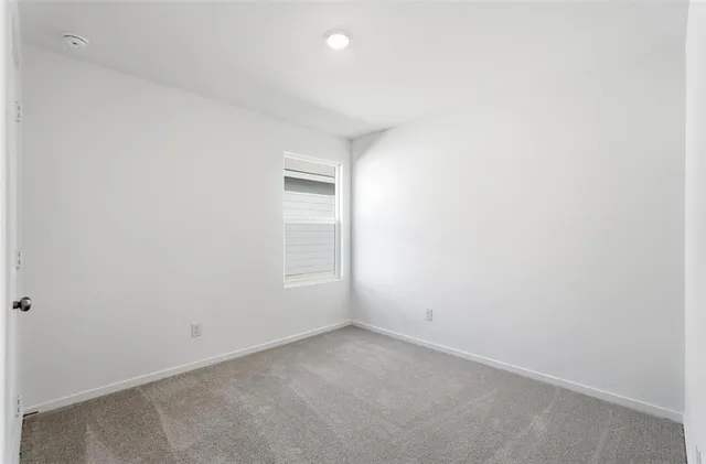 an empty room with a empty space and window