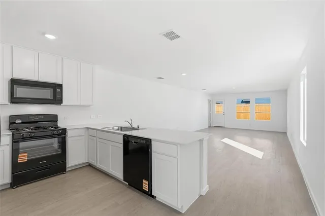 a kitchen with stainless steel appliances granite countertop a stove and a sink