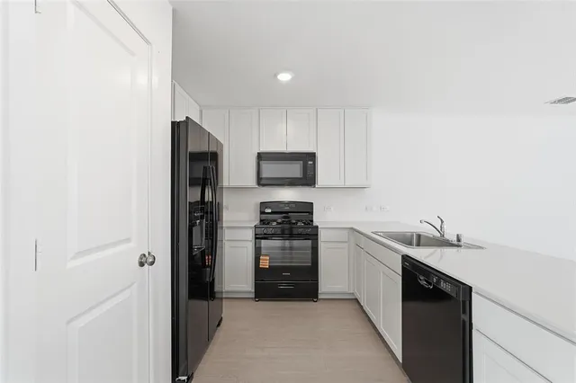 a kitchen with a sink cabinets and stainless steel appliances
