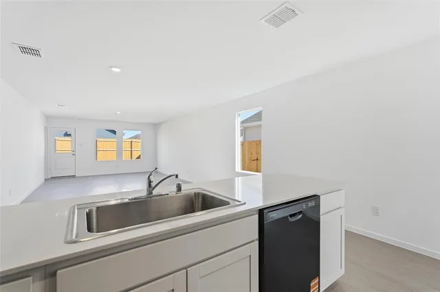 a kitchen with a sink and cabinets