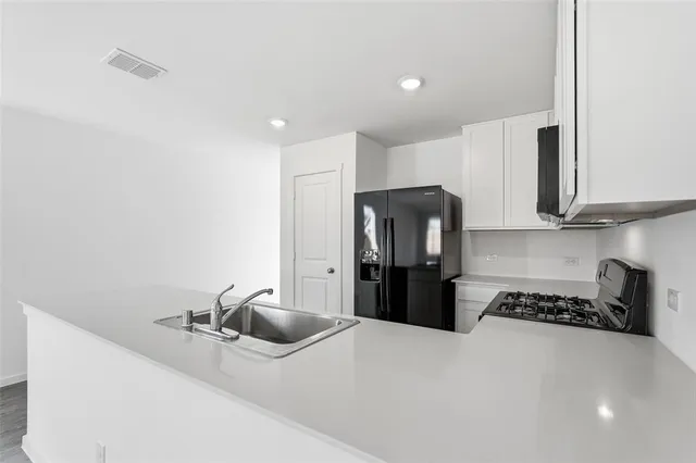 a kitchen with refrigerator and stove