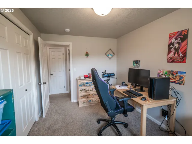 a bedroom with a bed a chair and a window