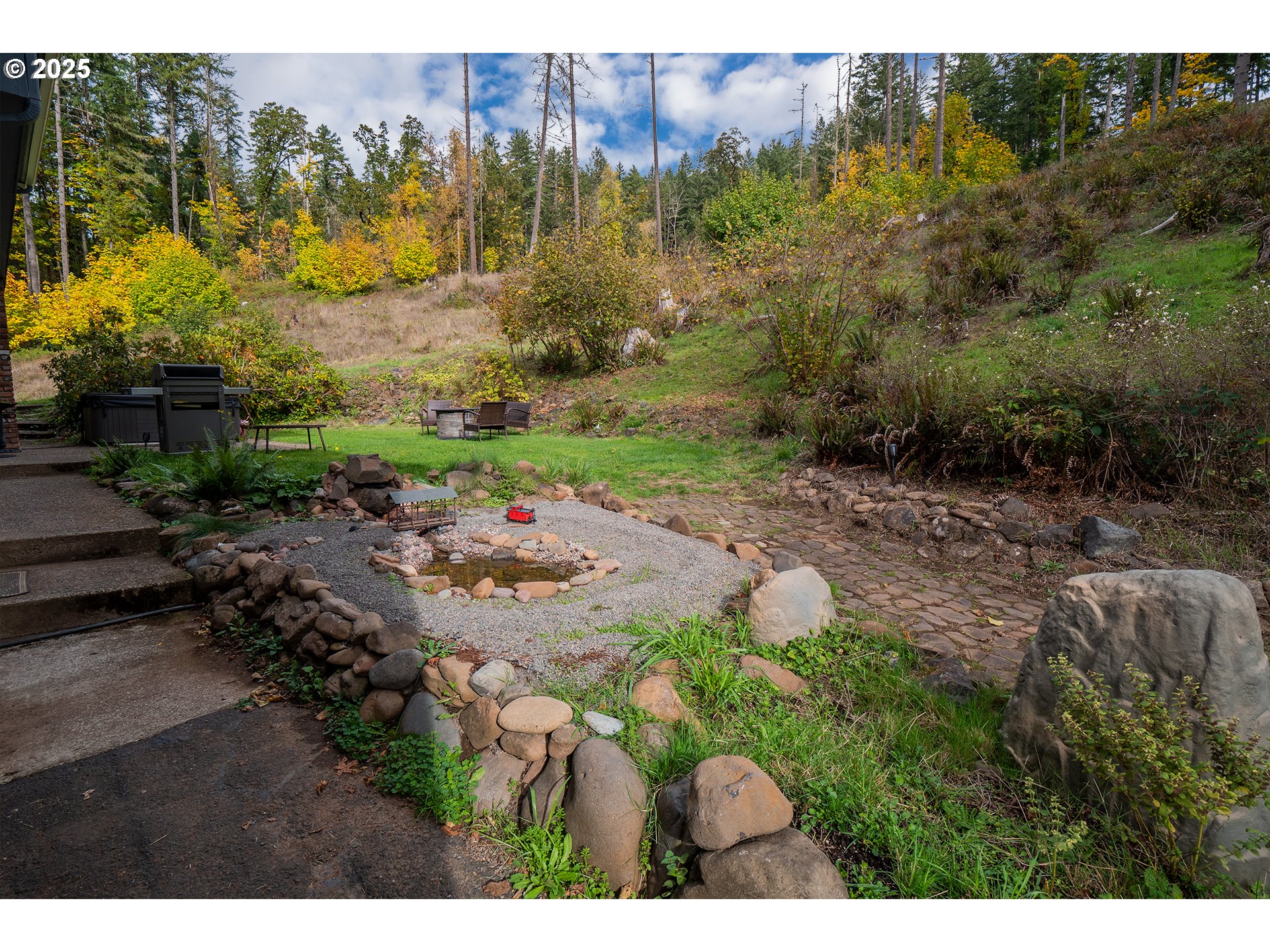 76377 Mosby Creek Road Cottage Grove, OR 97424 - Photo 30 of 48 a backyard of a house with a yard and outdoor seating