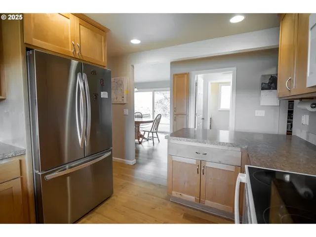 a kitchen with kitchen island a counter top space cabinets and stainless steel appliances
