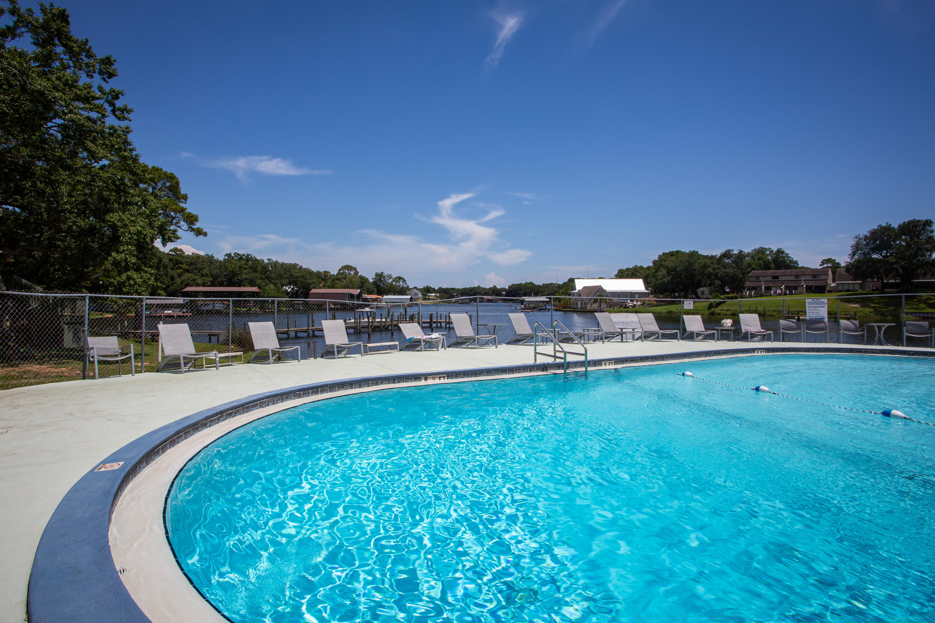210 Pelham Road, Unit 209A Fort Walton Beach, FL 32547 - Photo 1 of 19 a view of a swimming pool and a yard