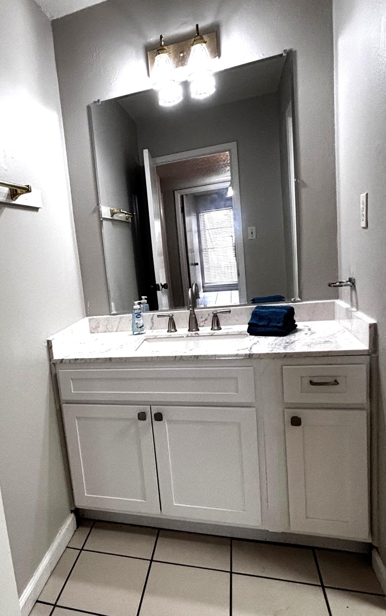 210 Pelham Road, Unit 209A Fort Walton Beach, FL 32547 - Photo 13 of 19 a bathroom with a sink vanity and a mirror