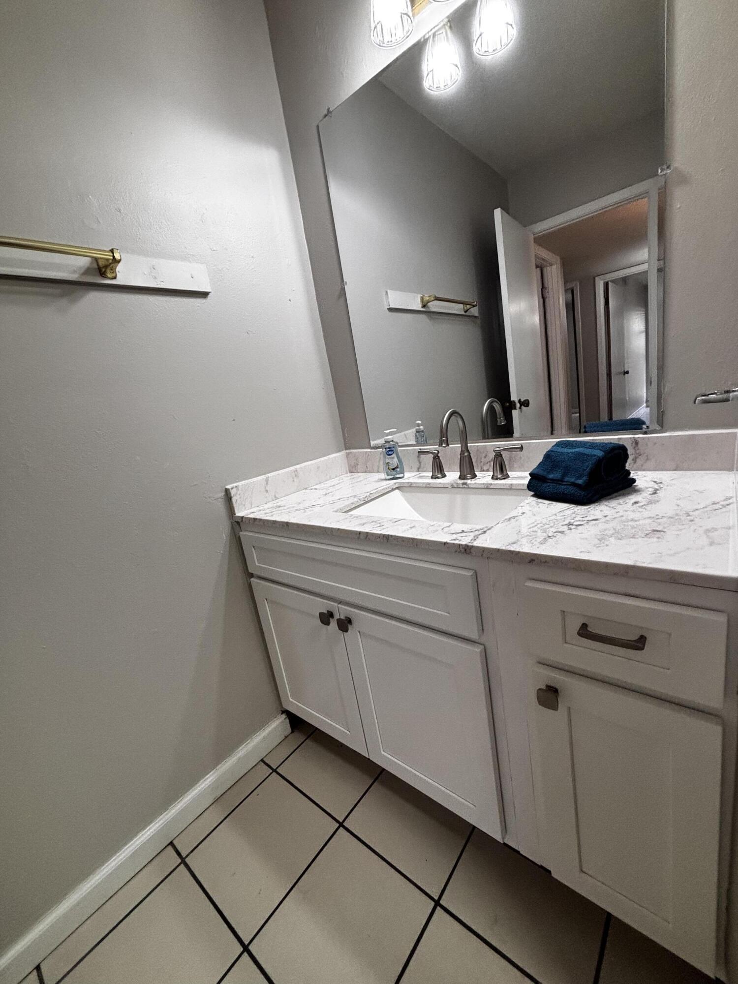 210 Pelham Road, Unit 209A Fort Walton Beach, FL 32547 - Photo 14 of 19 a bathroom with a sink and a mirror