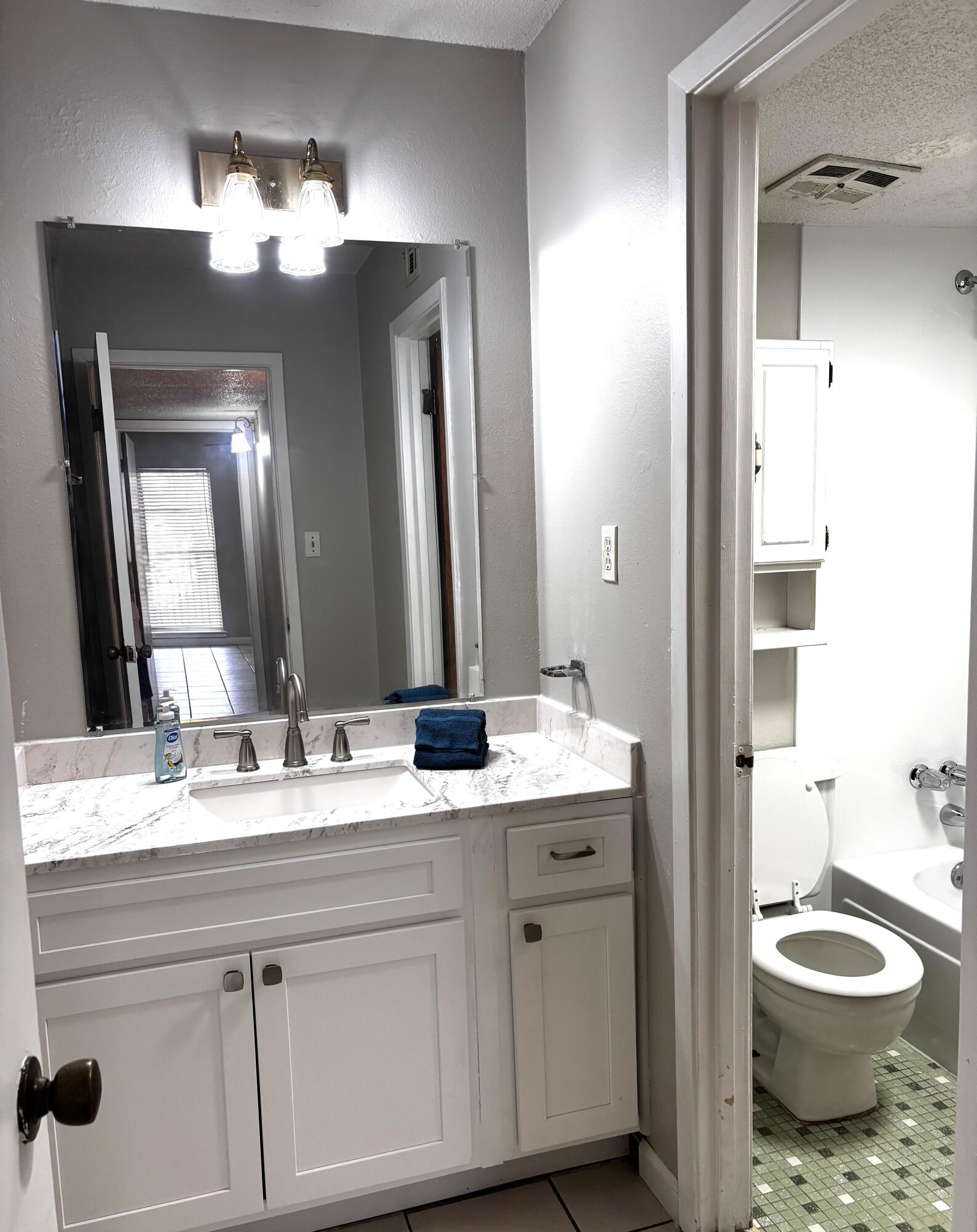 210 Pelham Road, Unit 209A Fort Walton Beach, FL 32547 - Photo 15 of 19 a bathroom with a toilet sink and mirror