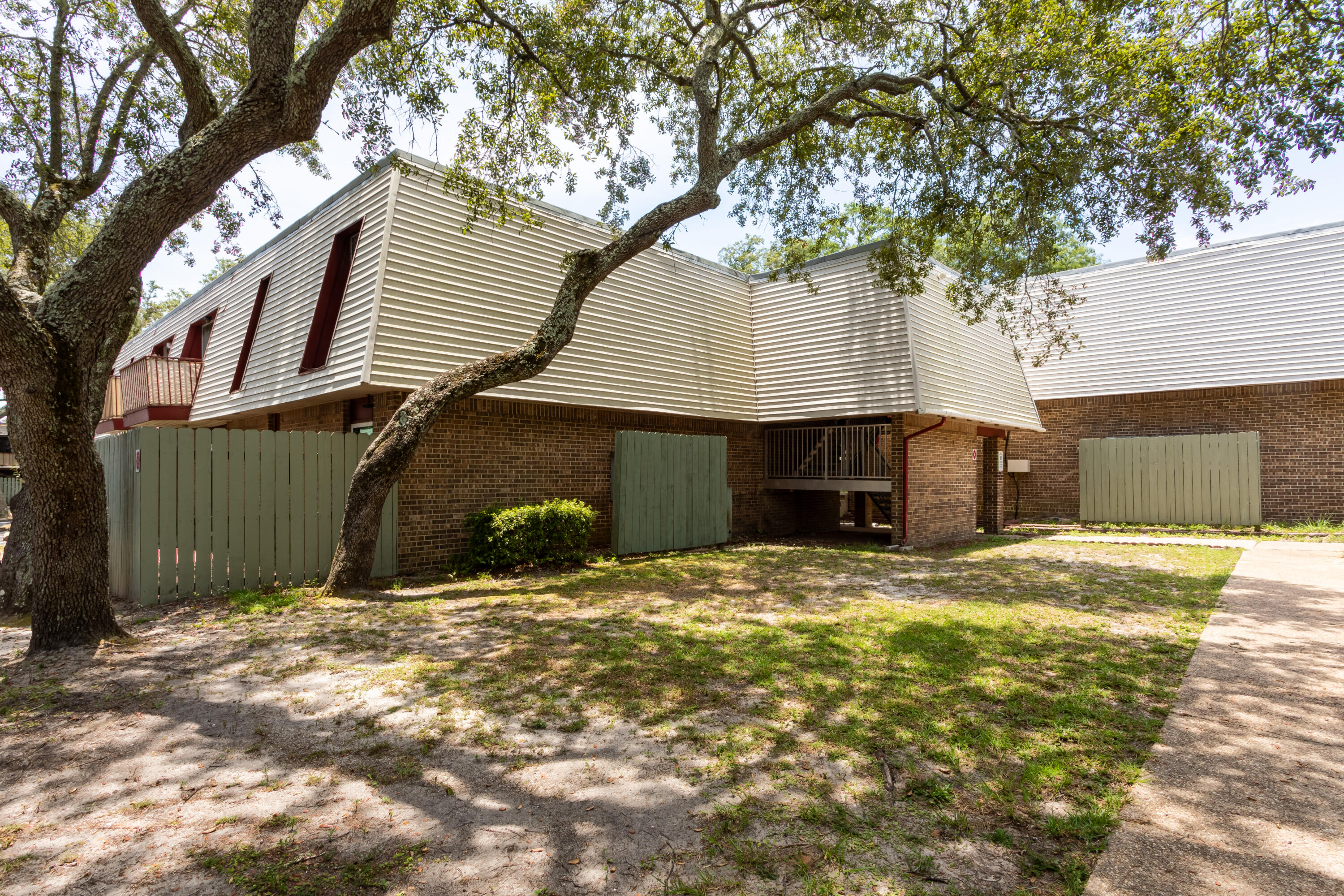 210 Pelham Road, Unit 209A Fort Walton Beach, FL 32547 - Photo 19 of 19 a front view of a house with a yard