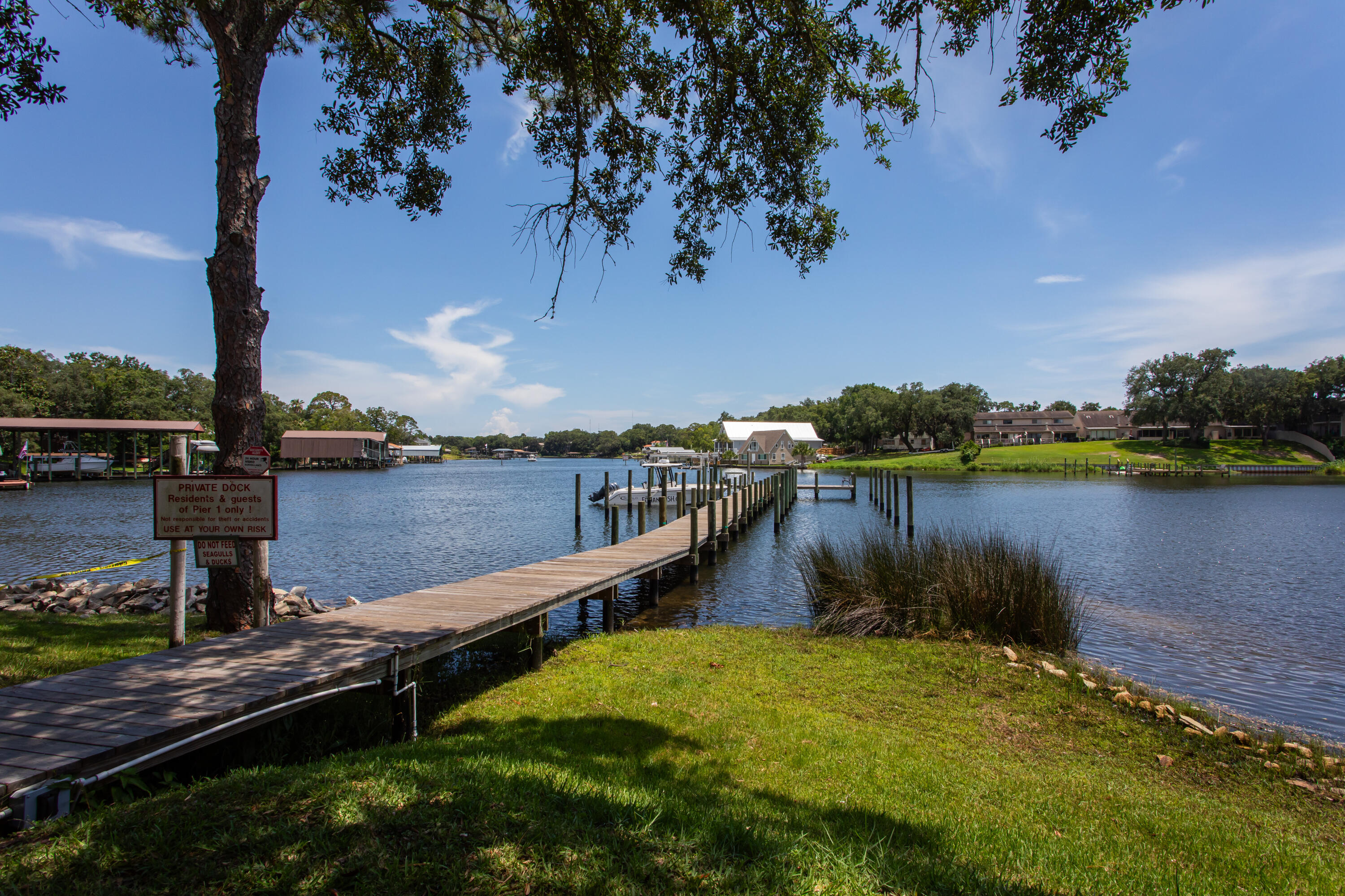 210 Pelham Road, Unit 209A Fort Walton Beach, FL 32547 - Photo 3 of 19 a view of a lake with houses in the back