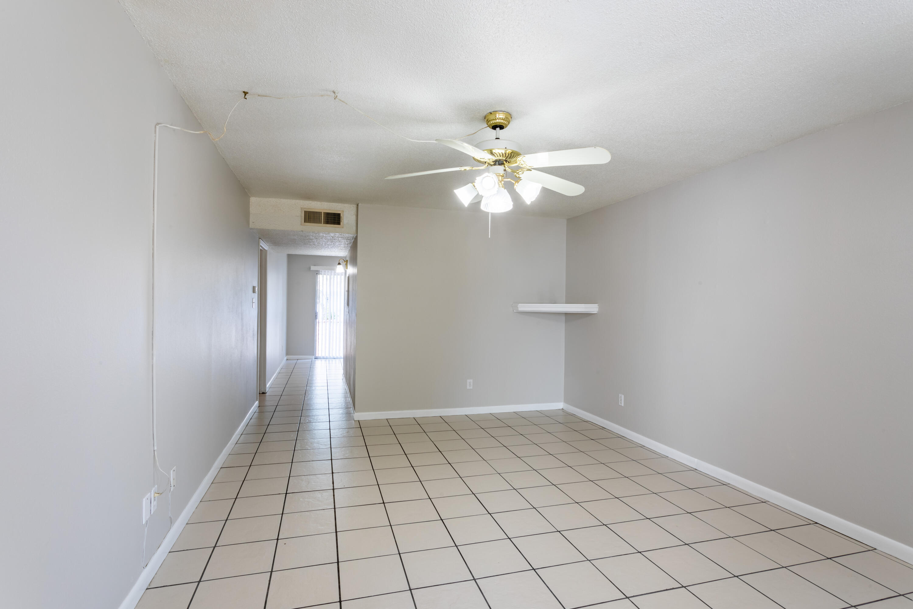 210 Pelham Road, Unit 209A Fort Walton Beach, FL 32547 - Photo 5 of 19 a view of an empty room and chandelier fan