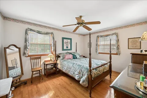 a bedroom with a bed window and a flat screen tv
