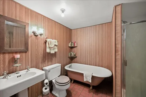 a bathroom with a toilet a sink and a mirror