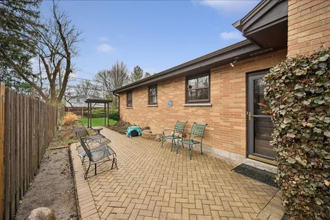 a backyard of a house with outdoor seating