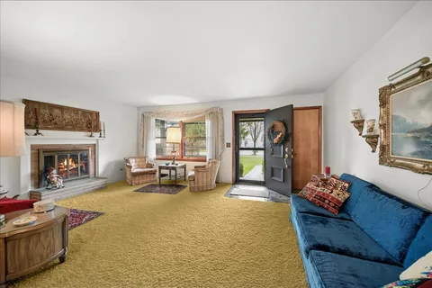 a living room with furniture fireplace and flat screen tv