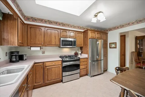 a kitchen with stainless steel appliances granite countertop a refrigerator stove and sink