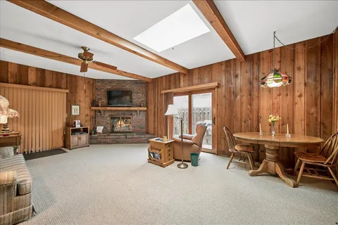 a view of a livingroom with furniture and a window
