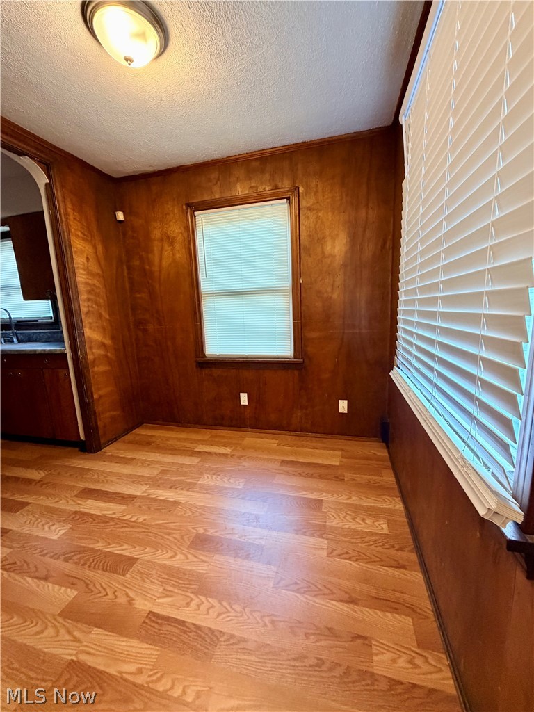 10506 Park Heights Road Cleveland, OH 44104 - Photo 6 of 22 Wood-finish flooring complemented by wood-paneled walls