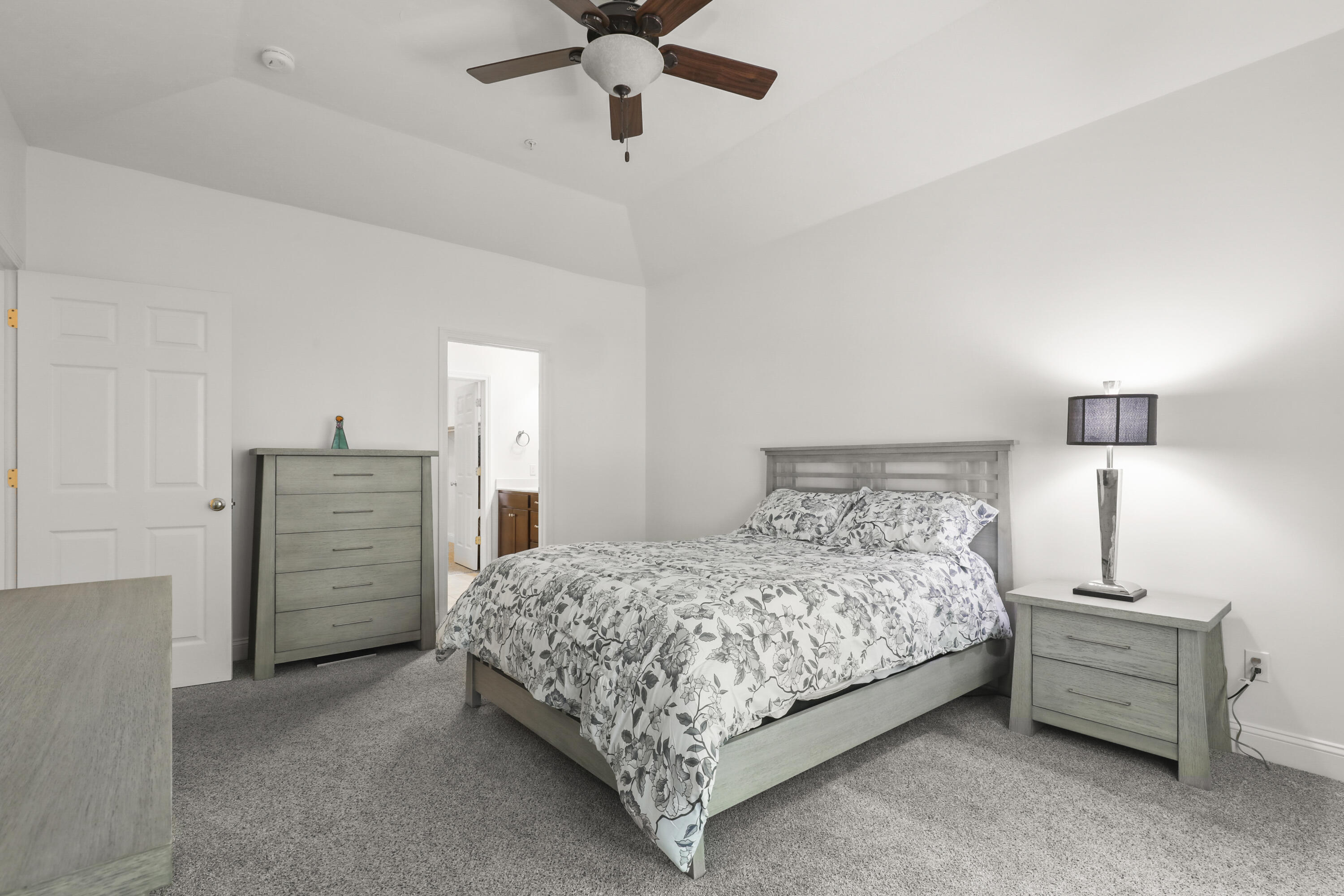 21 Grey Hawk Drive, Unit 21 Mashpee, MA 02649 - Photo 14 of 34 a bedroom with a bed and a lamp on the dresser