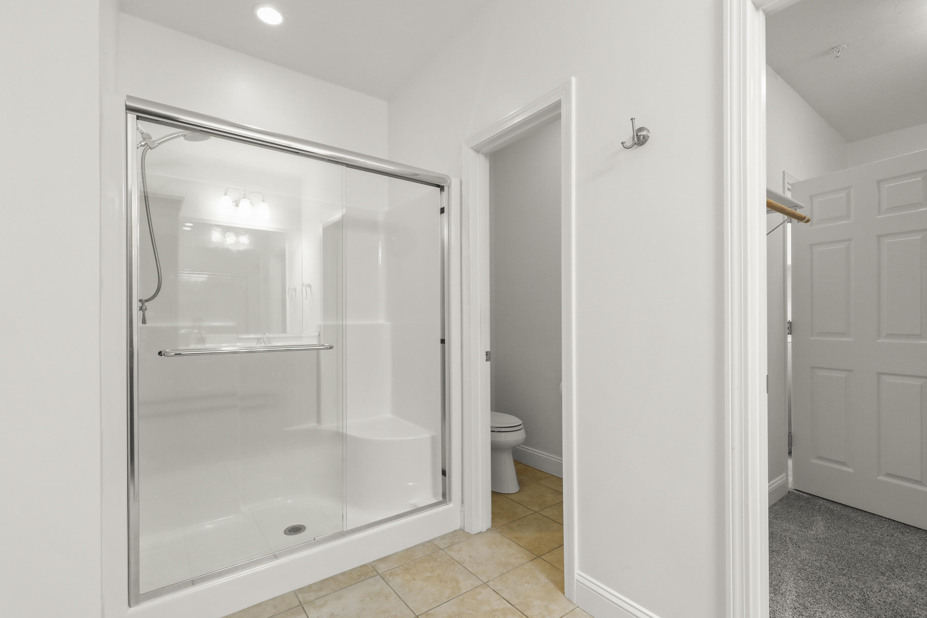 21 Grey Hawk Drive, Unit 21 Mashpee, MA 02649 - Photo 20 of 34 a bathroom with a glass shower door