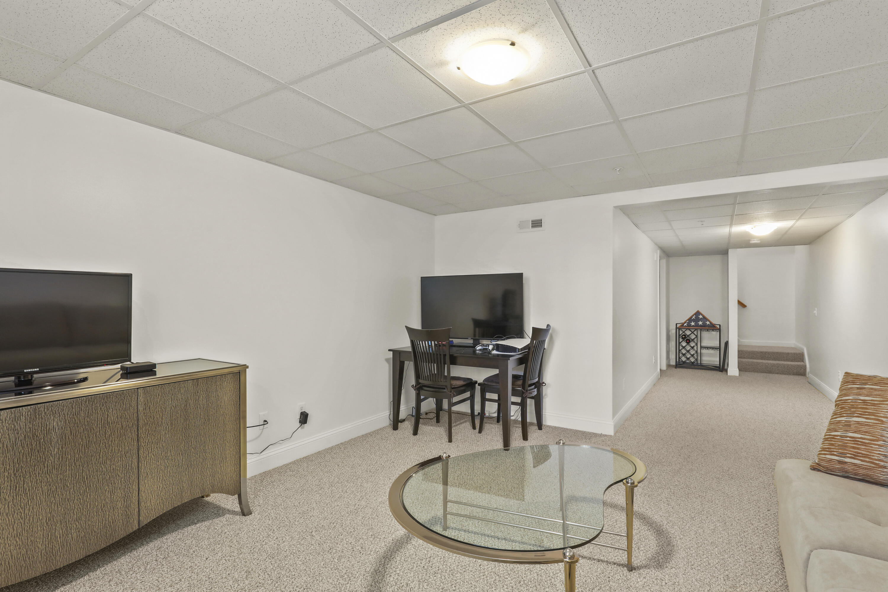 21 Grey Hawk Drive, Unit 21 Mashpee, MA 02649 - Photo 21 of 34 a living room with furniture and a flat screen tv