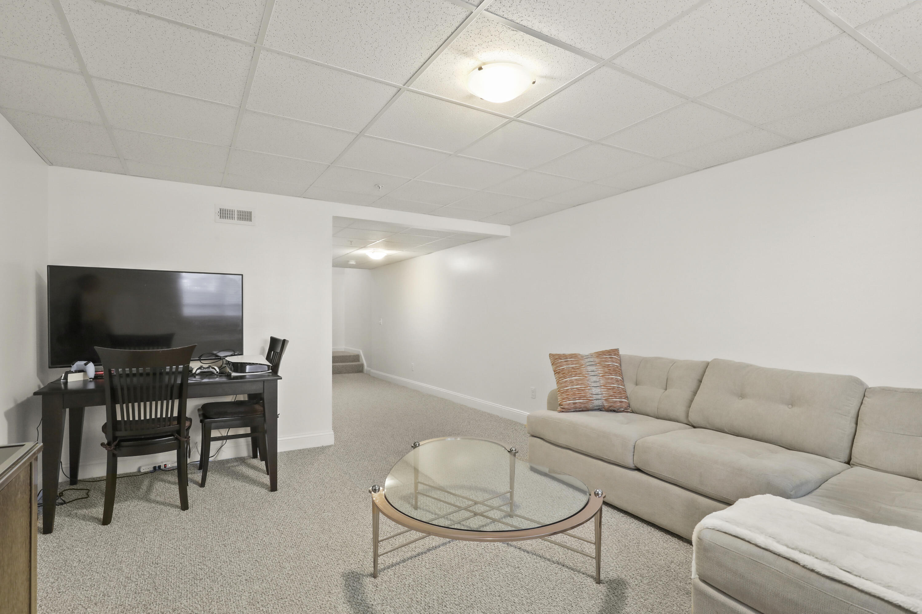 21 Grey Hawk Drive, Unit 21 Mashpee, MA 02649 - Photo 22 of 34 a living room with furniture and a flat screen tv