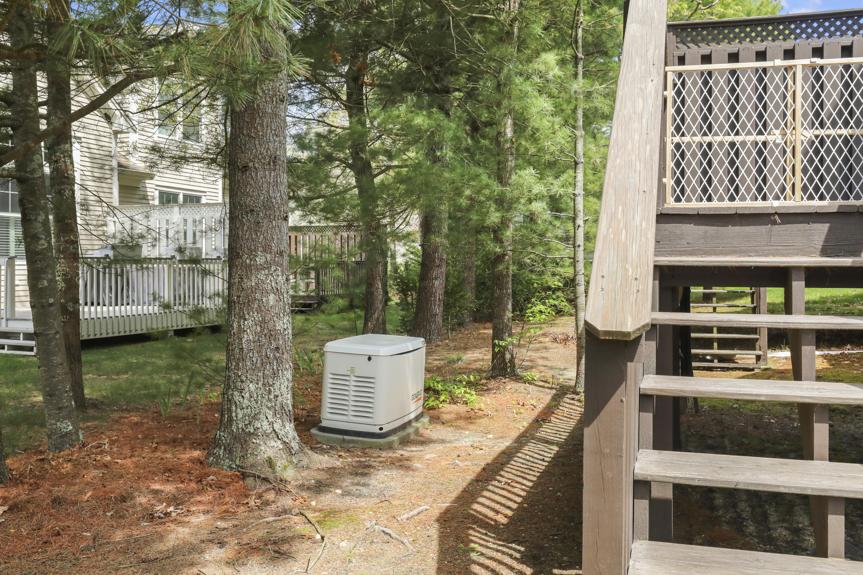 21 Grey Hawk Drive, Unit 21 Mashpee, MA 02649 - Photo 27 of 34 a view of a patio with table and chairs and wooden fence