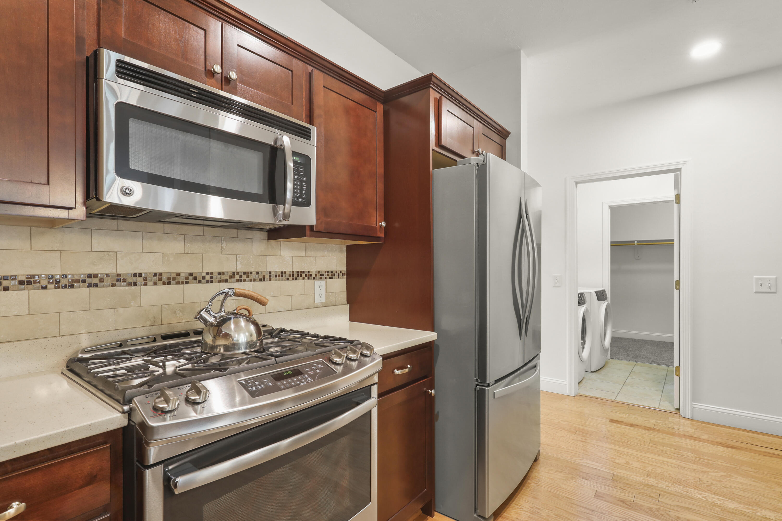 21 Grey Hawk Drive, Unit 21 Mashpee, MA 02649 - Photo 6 of 34 a kitchen with stainless steel appliances and a stove top oven