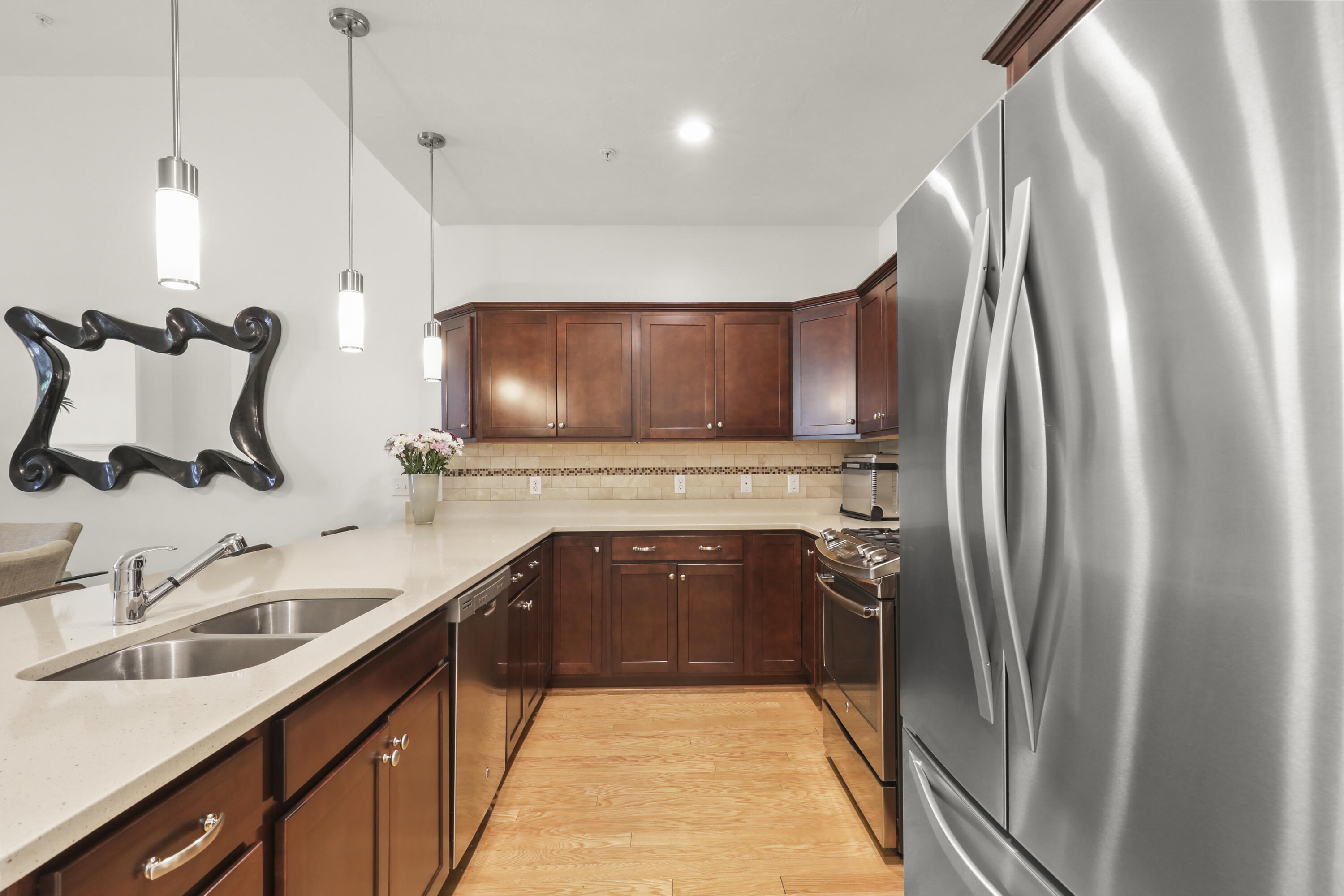 21 Grey Hawk Drive, Unit 21 Mashpee, MA 02649 - Photo 7 of 34 a kitchen with stainless steel appliances granite countertop a sink and a refrigerator