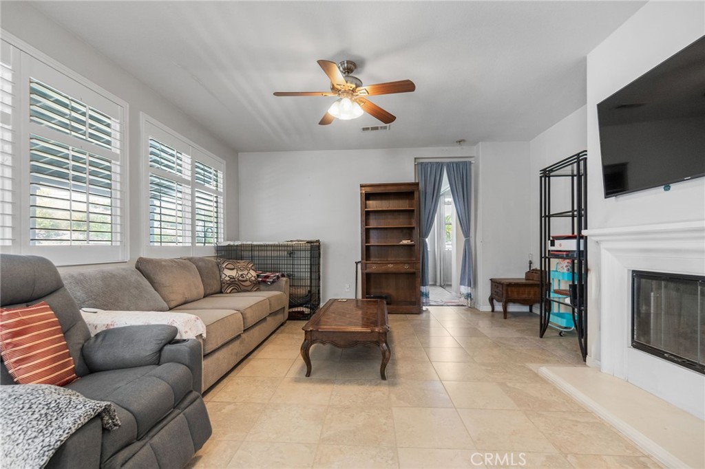 6136 Walnut Grove Court Rancho Cucamonga, CA 91739 - Photo 12 of 41 a living room with furniture a fireplace and a flat screen tv