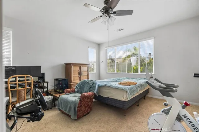 a bedroom with bed couch and window