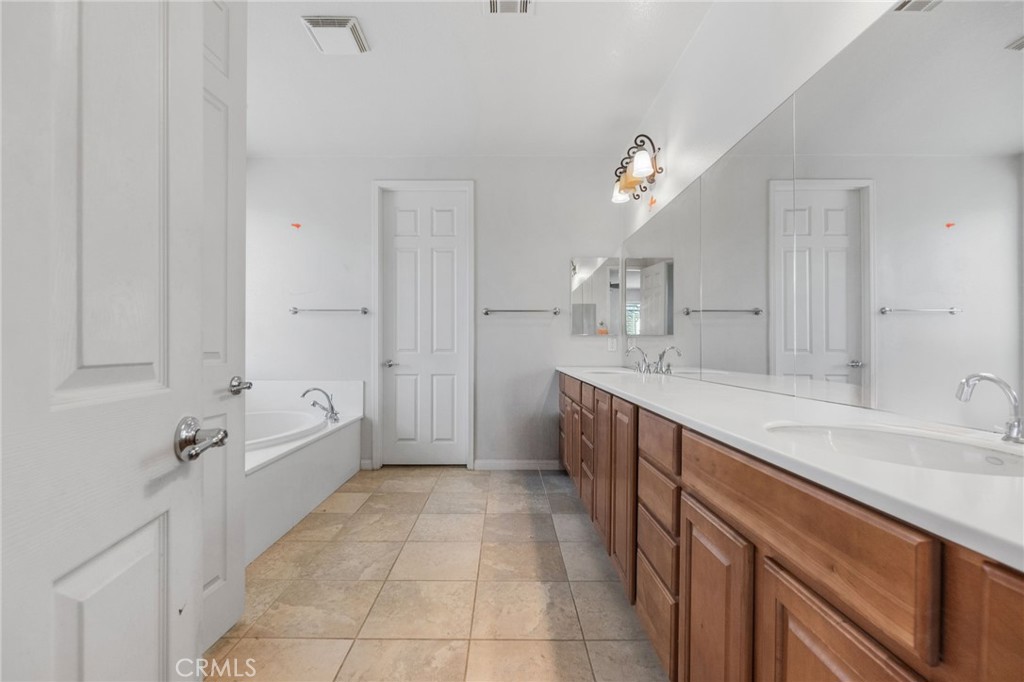 6136 Walnut Grove Court Rancho Cucamonga, CA 91739 - Photo 25 of 41 a spacious bathroom with a sink a mirror and a bathtub