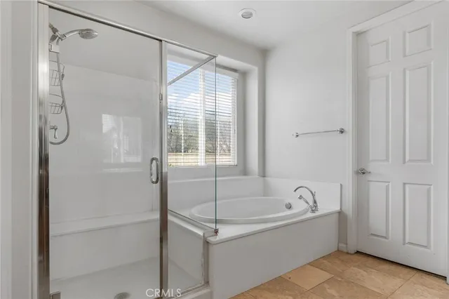 a white bath tub sitting next to a shower