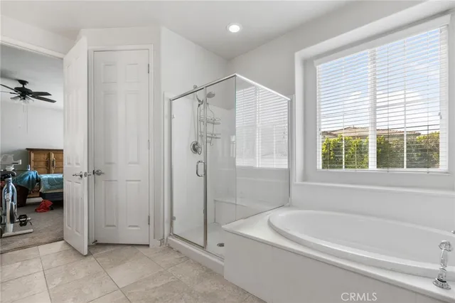 a bathroom with a tub a shower and a sink