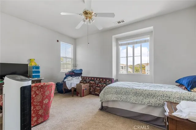 a bedroom with 2 bed and a window