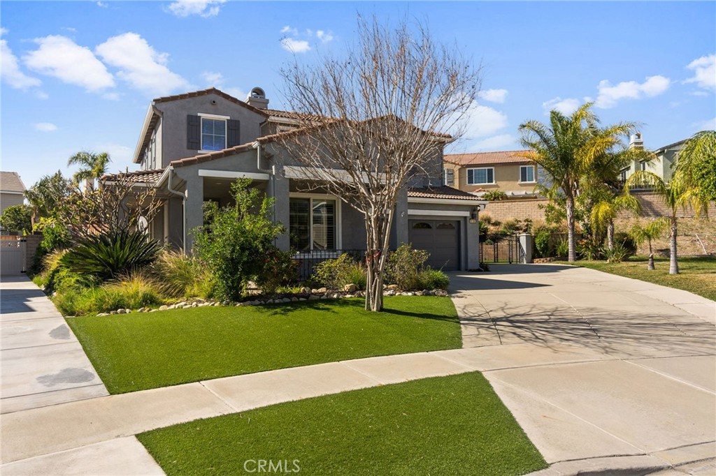 6136 Walnut Grove Court Rancho Cucamonga, CA 91739 - Photo 3 of 41 a front view of a house with a yard