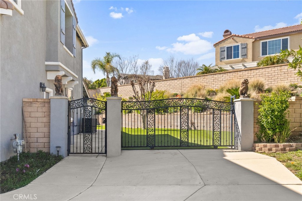 6136 Walnut Grove Court Rancho Cucamonga, CA 91739 - Photo 39 of 41 a view of a brick house that has large tree and a yard