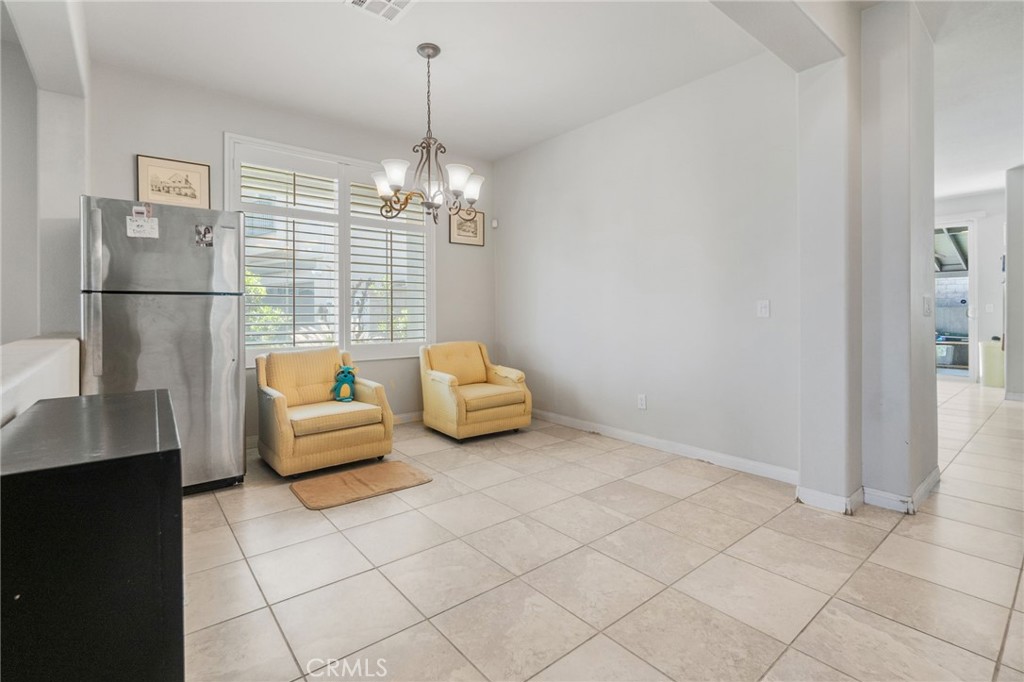 6136 Walnut Grove Court Rancho Cucamonga, CA 91739 - Photo 8 of 41 a living room with furniture and a chandelier