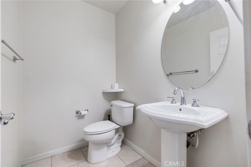 6136 Walnut Grove Court Rancho Cucamonga, CA 91739 - Photo 10 of 41 a bathroom with a toilet a sink and mirror
