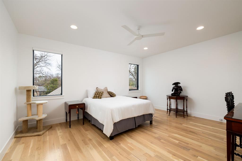 5019 Lark Lane Dallas, TX 75209 - Photo 17 of 32 a bedroom with a bed and a table