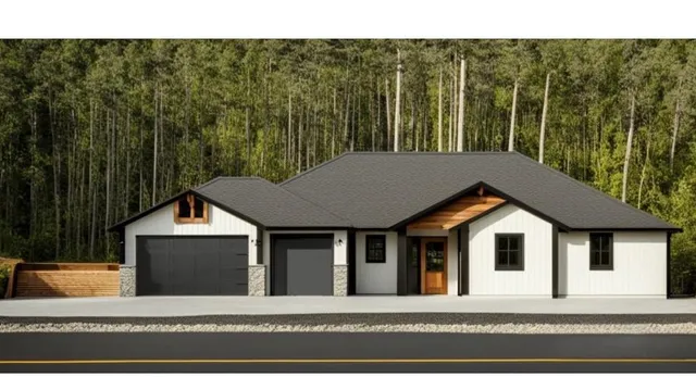 a view of a white house next to a yard