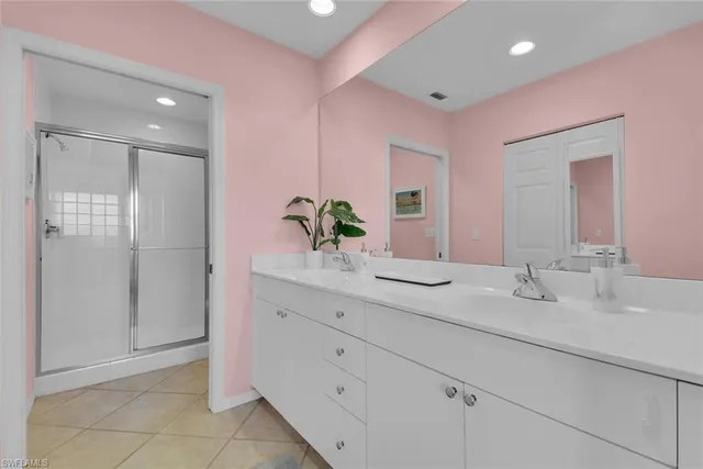 a bathroom with a granite countertop sink a mirror and a shower
