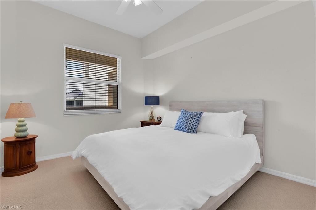 450 Launch Circle, Unit 602 Naples, FL 34108 - Photo 14 of 27 a bedroom with a bed and a window