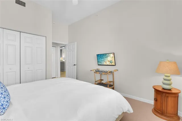 a bedroom with a bed and a lamp on table