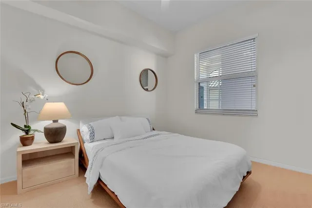 a bedroom with a bed and cabinets