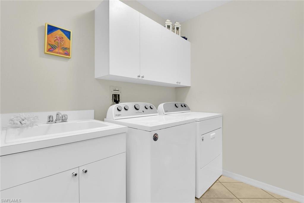 450 Launch Circle, Unit 602 Naples, FL 34108 - Photo 19 of 27 a utility room with dryer and washer