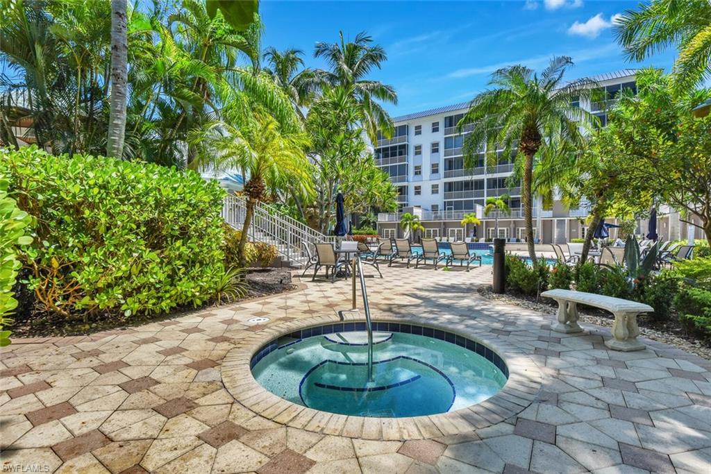 450 Launch Circle, Unit 602 Naples, FL 34108 - Photo 27 of 27 a swimming pool with outdoor seating and plants