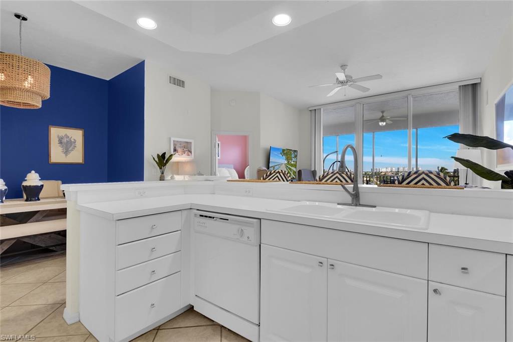 450 Launch Circle, Unit 602 Naples, FL 34108 - Photo 6 of 27 a kitchen with cabinets and sink